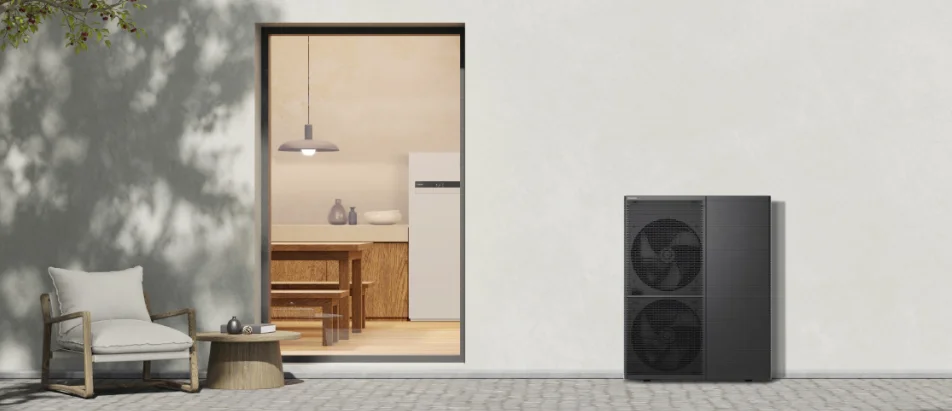 Modern air-source heat pump installed outside a white-walled home, next to a minimalist patio and energy-efficient interior space.